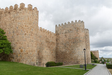 Fototapeta na wymiar Detailed view of Ávila city Walls and fortress tower, blue sky as background