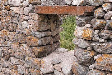 Stone wall with window in traditional balkarian house in old Verhnyaya Balkaria village. Kabardino-Balkaria, Caucasus, Russia.