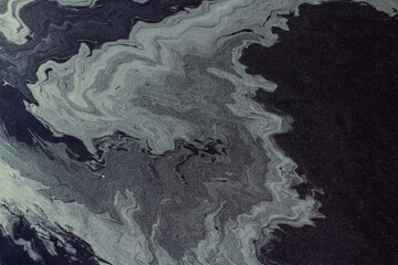 Pollen in a puddle. Beautiful stains in the water.