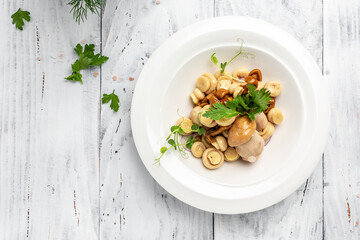 Marinated mushrooms in a bowl on wooden background, banner, menu, recipe place for text, top view