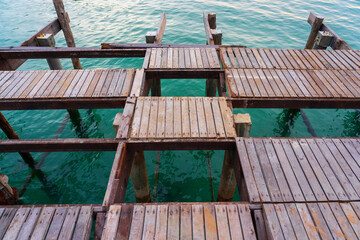 Fototapeta na wymiar Broken wooden platform with green water background