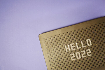 Hello 2022 on message board flat lay. Blue background. Greeting New Year concept