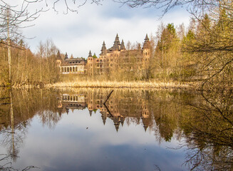 Fototapeta na wymiar Łapalice, Poland - built in 1983 but never finished, the ruins of Łapalice Castle are an interesting tourist attractions in northern Poland. Here in particular its shape reflecting in the nearby lake