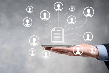 Man hold document and user icon.Corporate data management system DMS and document management system concept. Businessman click or publish on document connected with corporate users