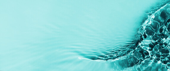 De-focused water waves in sunlight background. Aqua-mint liquid colored clear water surface texture...