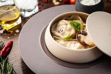 Black Angus beef hand-made dumplings. Cucumber-julienne with chilli-garlic butter and sour cream. Delicious healthy traditional food closeup served for lunch in modern gourmet cuisine restaurant