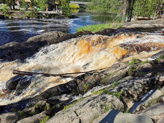 Side view of the Ahvenkoski waterfall on the Tokhmayoki River in Karelia on a clear summer morning..