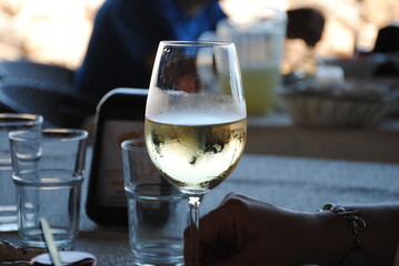 Glass of chilled  white wine on the restaurant table.