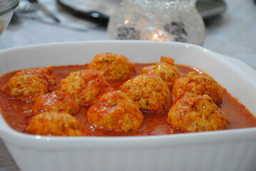 Meatballs in sweet and sour tomato sauce with spices served in deep square plate