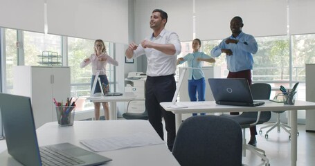 Group of happy young diverse businesspeople doing stretching exercise in office
