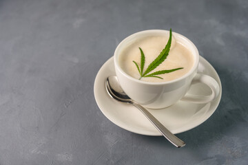 Hot Coffee drink with cannabis leaf on top of foam