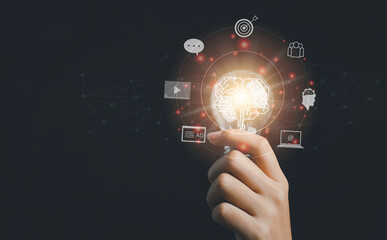 Fototapeta premium Digital marketing strategy idea concept. Content creator holding a bright light bulb great creative for target with virtual icon.