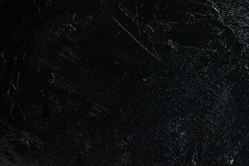 Dark creative background - rough linen canvas unevenly covered with black primer, reflections of...