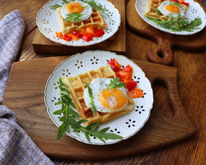 Healthy breakfast . Freshly made, delicious meal of eggs and vegetables. Gluten-free buckwheat waffles with fried eggs Top view