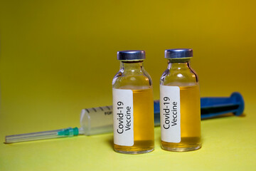 Coronavirus Covid-19 vaccine with syringe isolated on Dark background