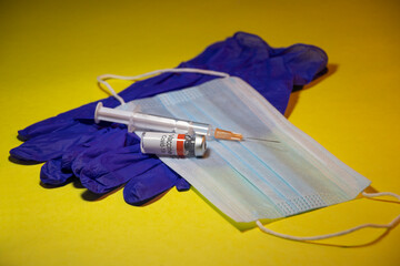 Coronavirus Covid-19 vaccine with syringe isolated on Yellow background