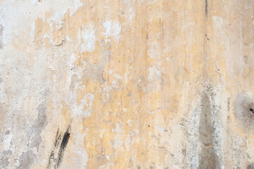 Fototapeta premium Old fading plaster wall texture, lack of maintenance, vintage background 