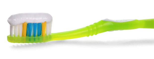 Green brush with toothpaste isolated on white