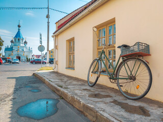 bicycle near the wall in the old Belarusian town of Postavy - obrazy, fototapety, plakaty