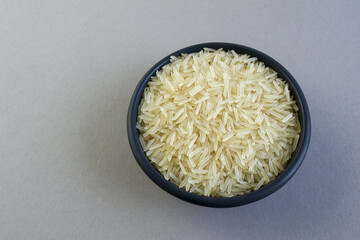 basmati rice in a black plate on a gray background