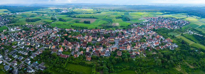 Fototapeta na wymiar Aerial view of the city Kalchreuth in Germany, on a cloudy day in spring.