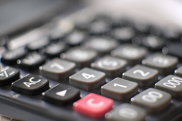 Close up calculator on wood table and macro calculator with number, business and finance concept