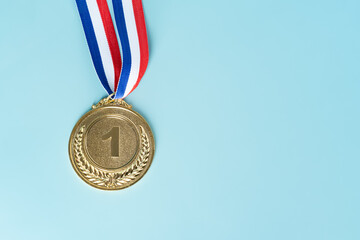 gold medal on blue background.award and victory concept.copy space