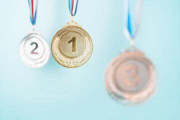 three medals (gold,silver,bronze) on blue background.concept of award and victory.copy space