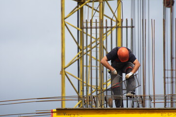 Workers and builders are building a housing complex made of concrete
