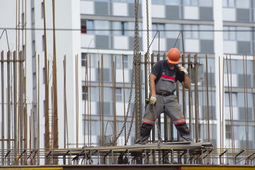 Workers and builders are building a housing complex made of concrete