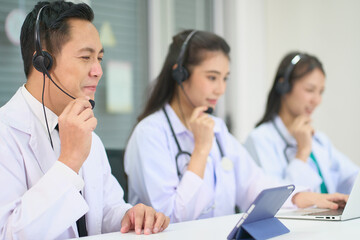 Team of asian doctors waer headset and help patient in online communication on laption for telecommunication healthcare medical service