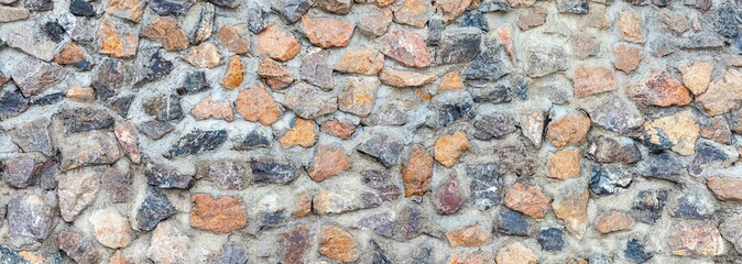 Panorama of Building exterior brown granite block wall texture and background seamless