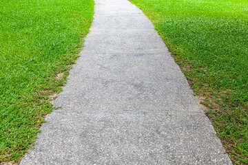 White natural stone pathway and green lawn