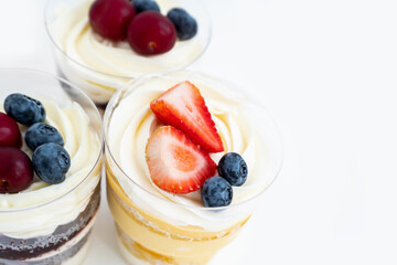 Top view of sweet cakes with cream and fresh berries