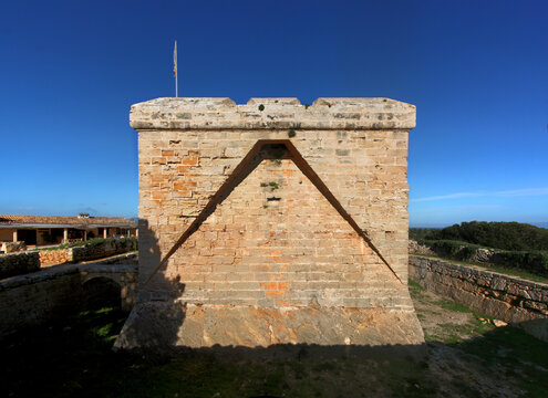Castle of Punta de n&rsquo;Amer with its moat and watchtower facade near Cala Millor on Mallorca island, Spain