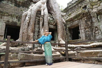 Happy woman traveller walking in Angkor Wat Cambodia.