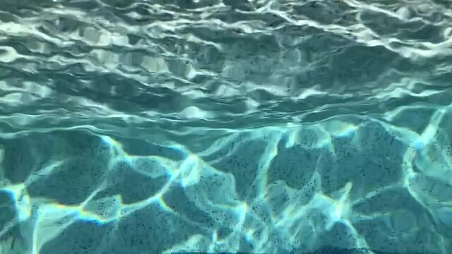 Waving blue water in a pool. Relaxation for the eyes, calm for the soul.