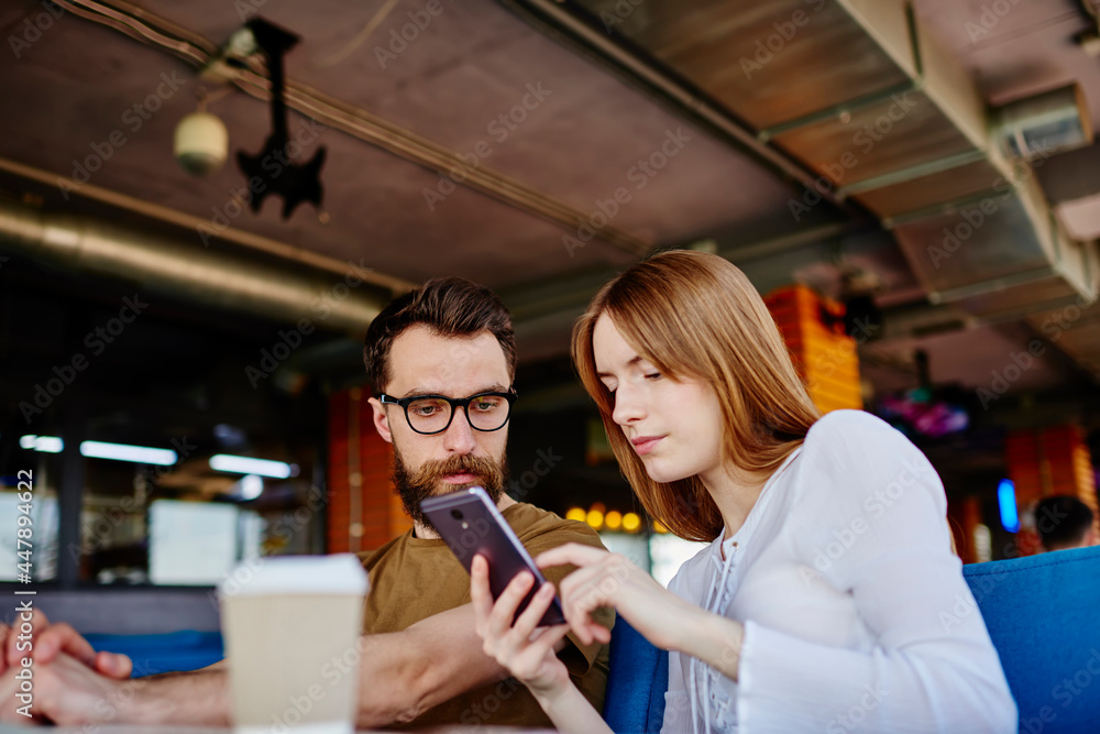 Poster millennial male and female users browsing web content via cellphone device connecting to 4g internet