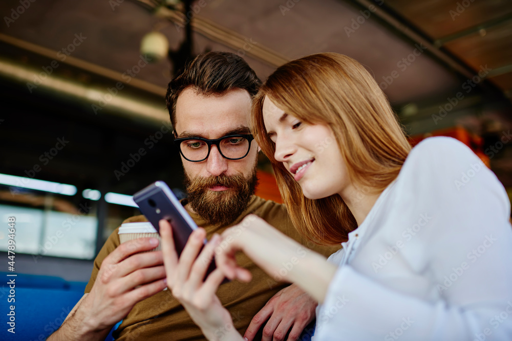 Poster young male and female bloggers using cellular device for installing media application and making onl