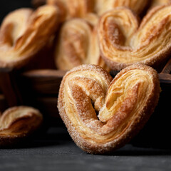 Puff pastry hearts, sweet cookies. Valentine Day concept. Soft focus. Side view. Close-up shot.