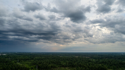 Naklejka na ściany i meble Aerial photo taken with a drone of a dark ominous grey storm clouds. Dramatic sky. lighting in dark stormy clouds. High quality photo