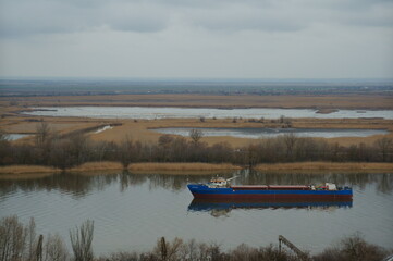 The barge is floating on the river.