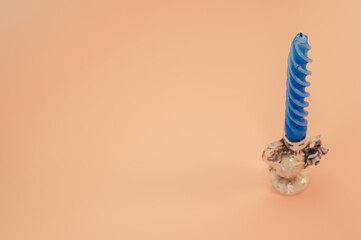 Closeup shot of a candle on a coral background