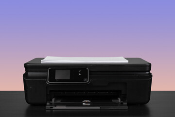 Home laser printer on desk against purple background