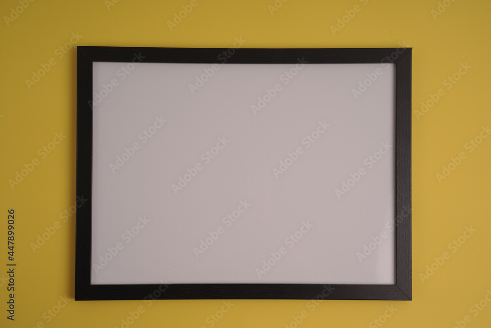 Poster black frame with empty white copy space for your content on a yellow background