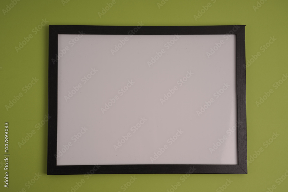 Poster black frame with empty white copy space for your content on a green background