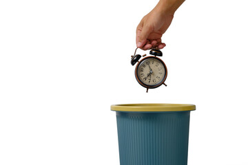 Man hand throws an alarm clock set for eight in morning into trash on white background.