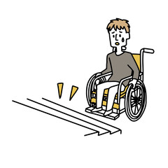 段差に困っている車椅子の若い男性