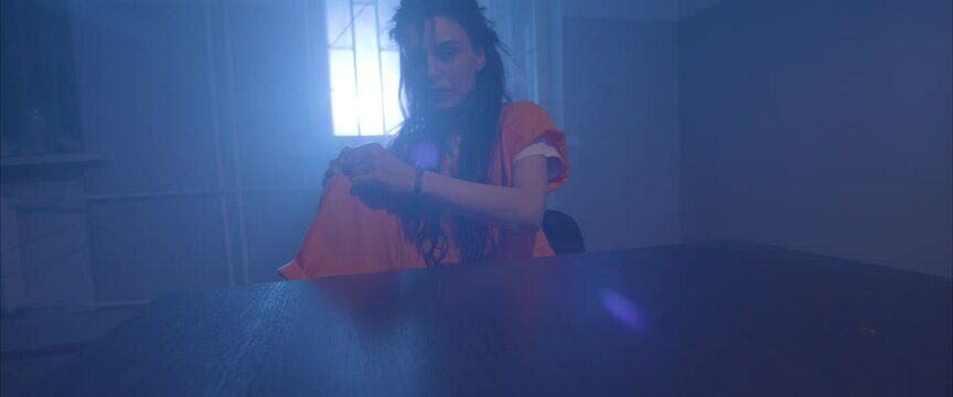 crazy girl  in the interrogation room in handcuffs