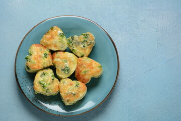 Healthy snack Broccoli muffins with cheddar cheese and thyme close-up on the table.